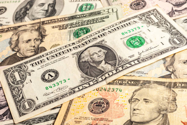 istock Close-up of multiple American dollar banknotes. 1203345697