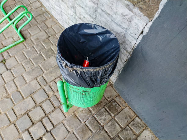istock Green bag for collecting garbage on the street. 1203345736