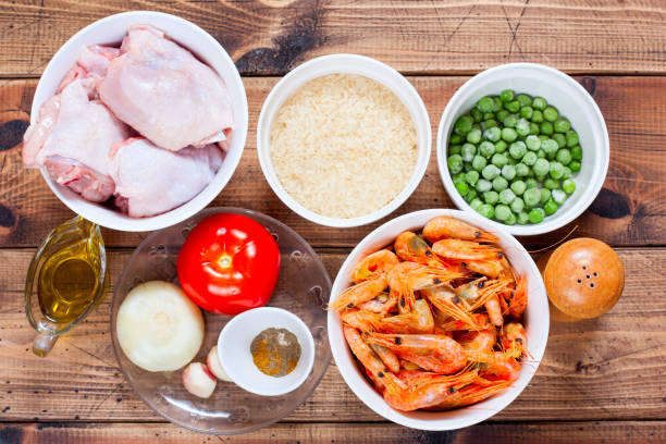 istock Step-by-step preparation of Spanish paella with chicken, shrimp and vegetables, step 1 - preparation of ingredients, selective focus, horizontal 1203349552