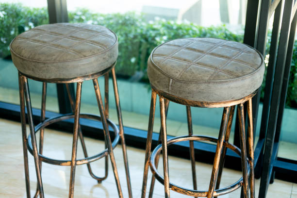 istock Metal bar stool with leather seat in coffee shop 1203349870