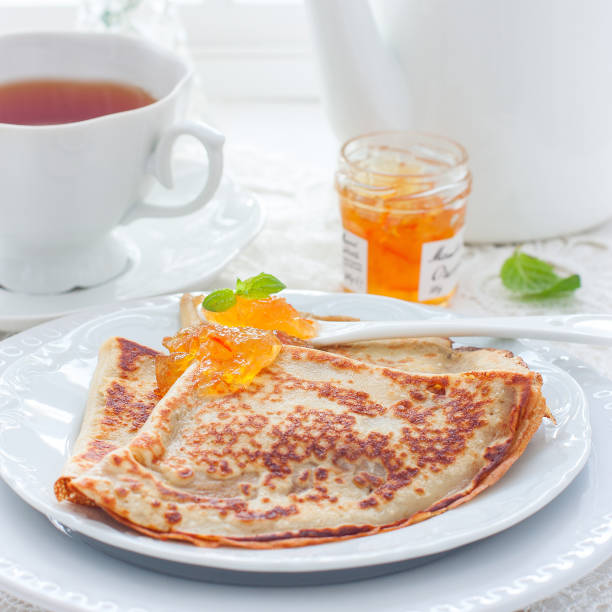 istock Breakfast with pancakes and orange jam, selective focus 1203350707