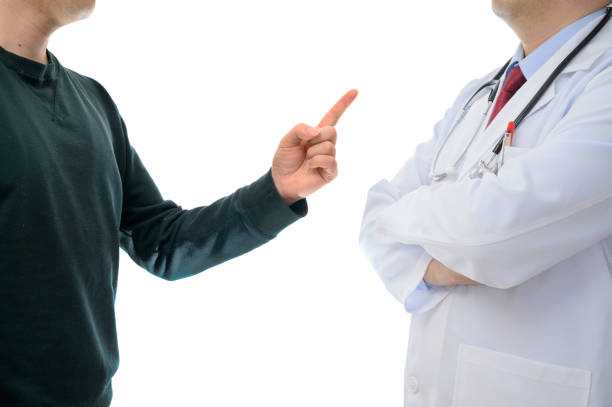 Patients protesting to the doctor. Medical dispute concept stock photo