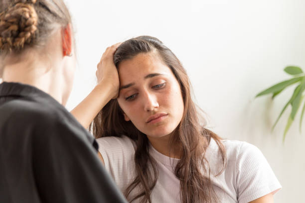 istock Depressed Young Woman with Girlfriend Near 1203352354