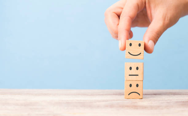 istock customer satisfaction concept. smiling face on sad face 1203354720