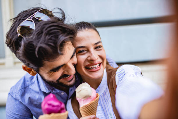 istock Portrait of a young couple with ice cream 1203354792
