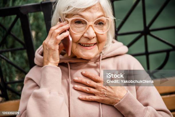 Joyful Old Lady Talking On Cell Phone Outdoors Stock Photo Stock Photo - Download Image Now