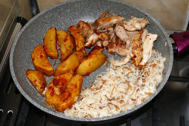 istock chicken potato meal and rice pilaf next to it, 1203358530