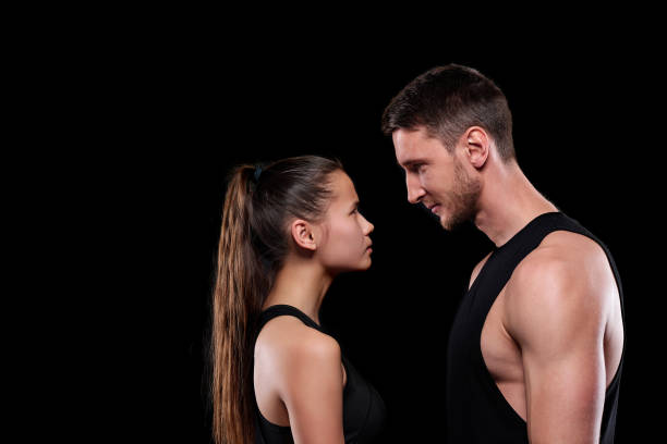 istock Young fit woman and man in activewear looking at one another 1203360498
