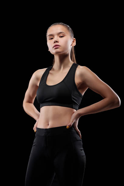 istock Young fit sportswoman keeping her hands on waist during physical training 1203360572