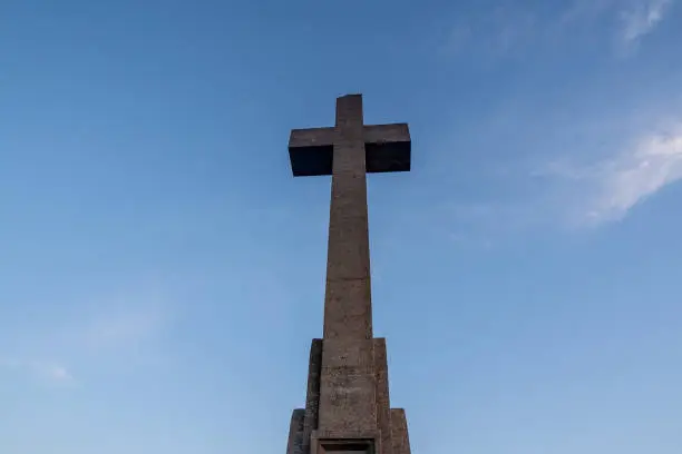 Photo of Sant Salvador big stone Cross in Majorca (Balearic Islands - Spain), Beautiful old stone cross during sunrise early in the morning