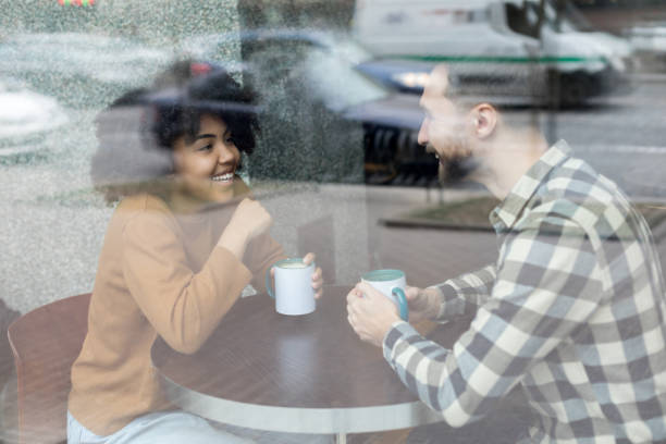 istock Happy young man and woman nice chatting in a cafe 1203361774