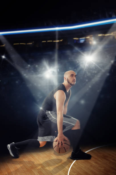 istock bald professional basketball player in the game dribbles 1203361859