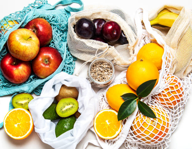 istock Mesh shopping bags with fruits 1203363350