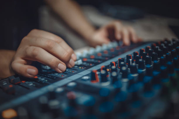 Hand with sound recording studio mixer