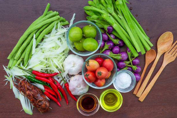 istock (SomTum) Raw materials for making Thai papaya salad include papaya, red tomatoes, paprika, garlic and lentils. Arranged beautifully on a dark green banana leaf ready for action 1203365802