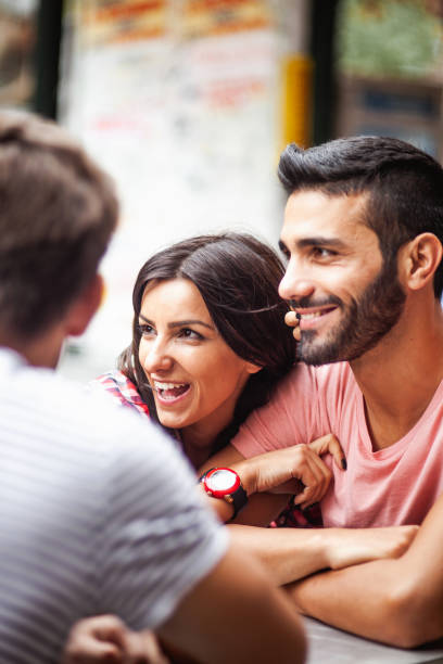 istock Young couple hanging out at a cafeteria 1203367653