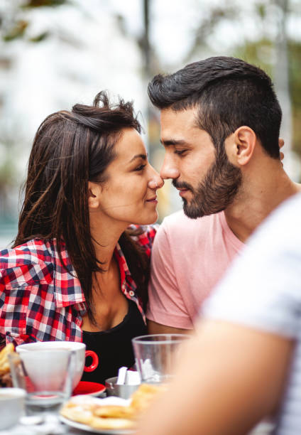 istock Young couple hanging out at a cafeteria 1203367743