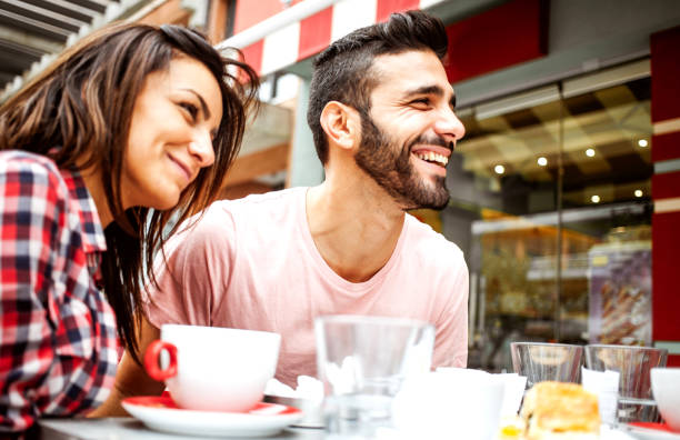 istock Young couple hanging out at a cafeteria 1203367989