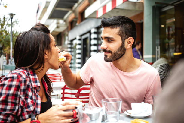 istock Young couple hanging out at a cafeteria 1203368203