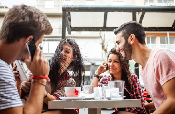 istock Young people hanging out at a cafeteria 1203369118