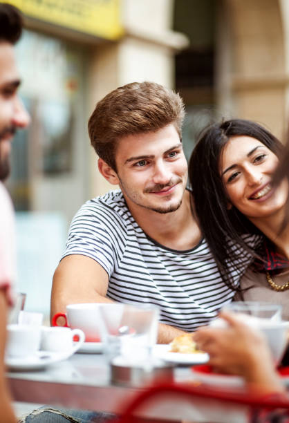 istock Young couple hanging out at a cafeteria 1203369119
