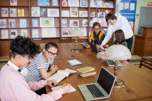 istock Two small groups of contemporary college students discussing points of projects 1203369302
