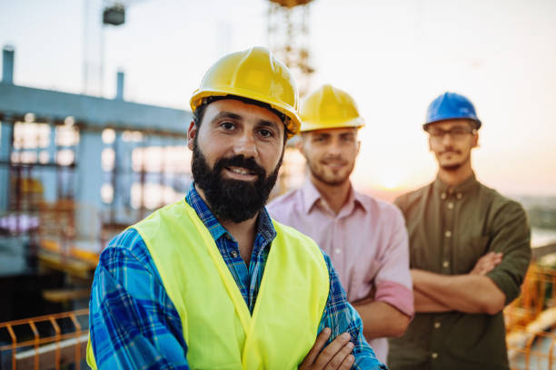 istock Portrait of engineer with beard and hardhat 1203370398