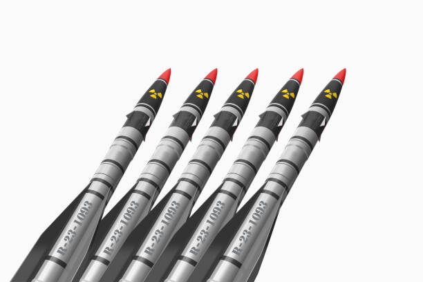 istock Five ballistic missiles with an atomic energy sign on a white background 1203370520