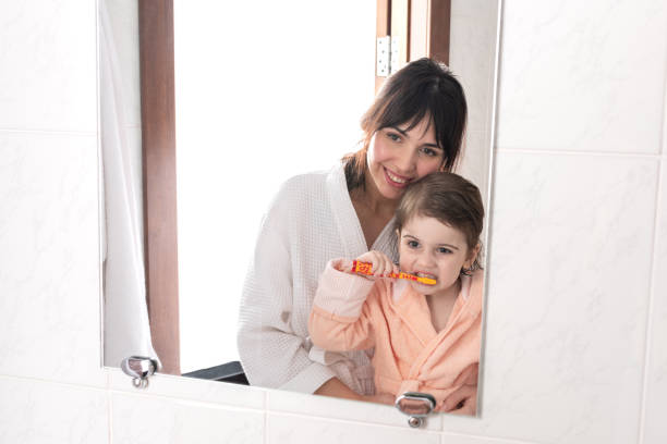 istock Mother teaches her baby to make daily hygiene routine. 1203371022