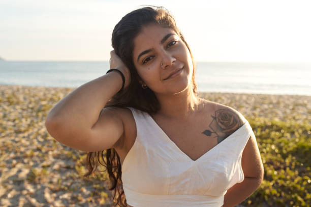 istock Woman at the beach looking at camera 1203371805