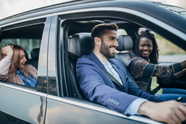 istock Cheerful friends driving in a car 1203372029