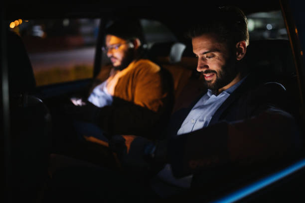 istock Men driving in a car and text messaging 1203372099