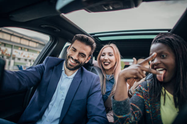 istock Happy friends in a car 1203374817