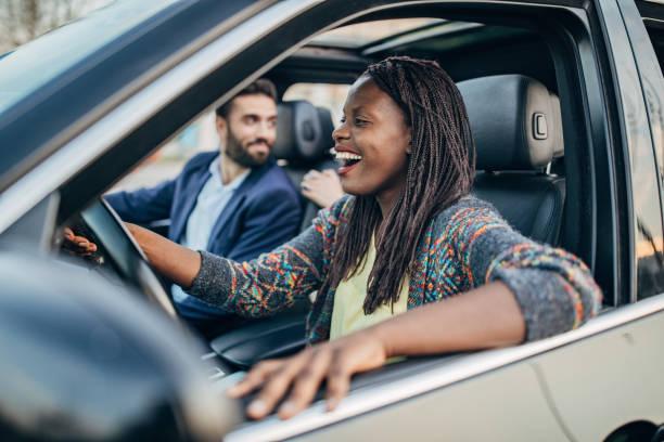 istock Cheerful friends traveling by a car 1203375819