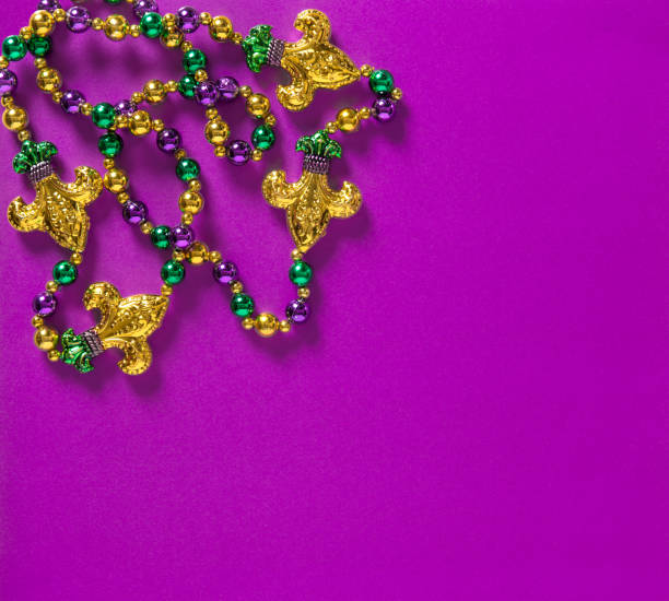 istock Mardi gras carnival decoration beads purple background 1203376030