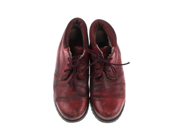 istock old red leather shoes isolated on white background 1203376031