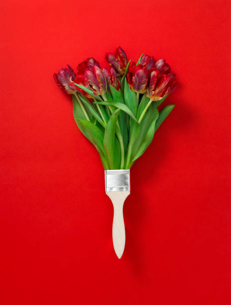 istock Red tulip flowers paint brush Creative floral flat lay 1203376070