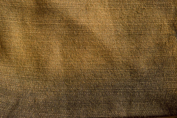 istock Dark black n yellow jeans texture for background 1203377162