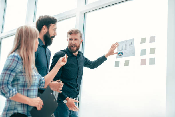 istock successful boss is discussing with the staff of financial performance 1203378288