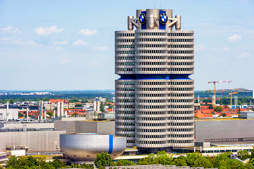 Munich, Germany - Aug 2, 2019: The BMW museum and world headquarters or BMW four-cylinder building in Munich, Bavaria. It is a landmark of city. Munich cityscape with famous tower in summer.
