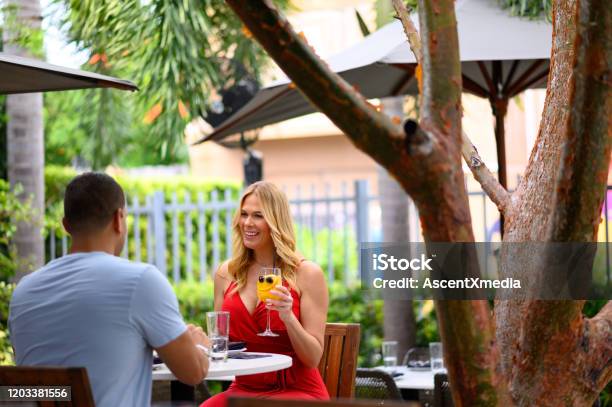 Smiling Couple Holding Hands At Restaurant Stock Photo - Download Image Now - Miami, Cocktail, Wynwood