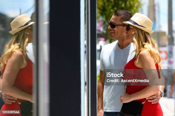 Smiling Couple Looking At Store Window In City Stock Photo - Download Image Now - Miami, Shopping, Store