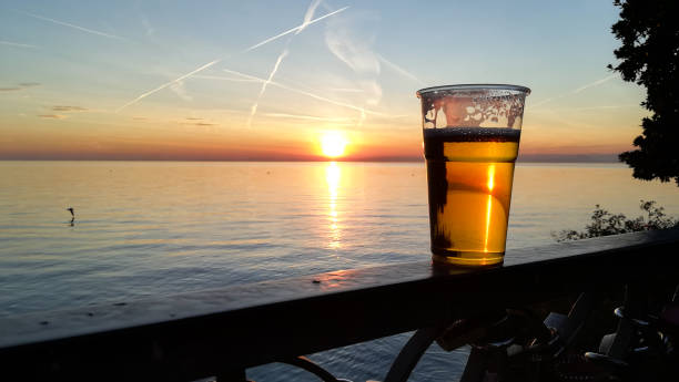 Cies  islands seen from sidewalk cafe , waterfront promenade by Samil beach near Vigo city, Pontevedra province, Galicia, Spain. Glass of beer and fried chip potatoes.
