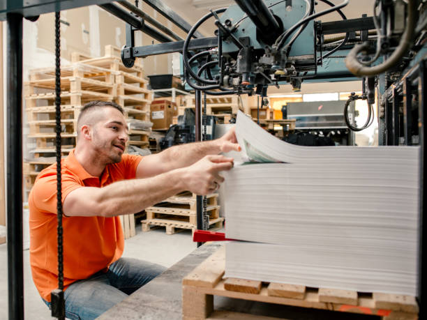 istock Workers in a printing factory 1203385892