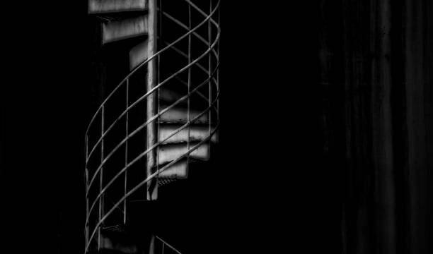 istock Black and white dark circular stairway 1203387782