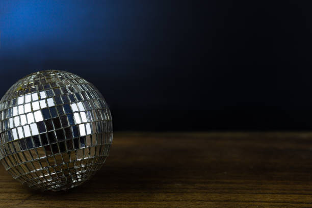 istock Disco ball on dark wooden floor background detail object art 1203389049