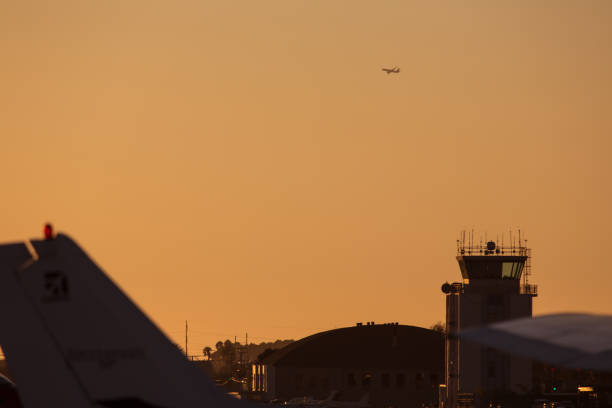istock Airplane departing at sunset 1203389466