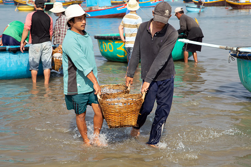 PHAN THIET, VIETNAM - Feb 16, 2015: People fisherman catch working at Vietnamese PHAN THIET harbour fishing village Vietnam. Travel Southeast Asia Coast Binh Thuan of Vietnam.