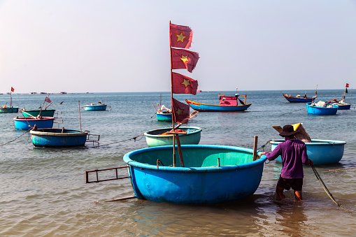 PHAN THIET, MUI NE, VIETNAM - Feb 16, 2015: Fisherman catch boats Vietnamese. People working at fishing pier in fishing village Phan Thiet, Travel Southeast Asia Coast Binh Thuan of Vietnam.
