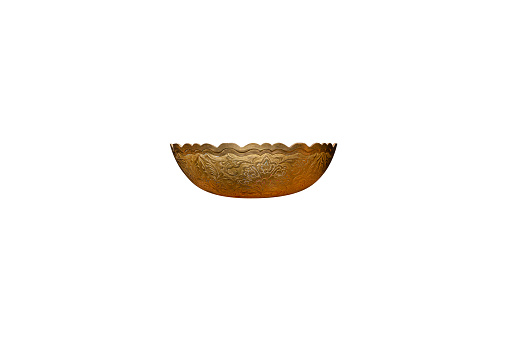 Copper bowl with flower-shaped decorations, isolated on a white background with a clipping path.